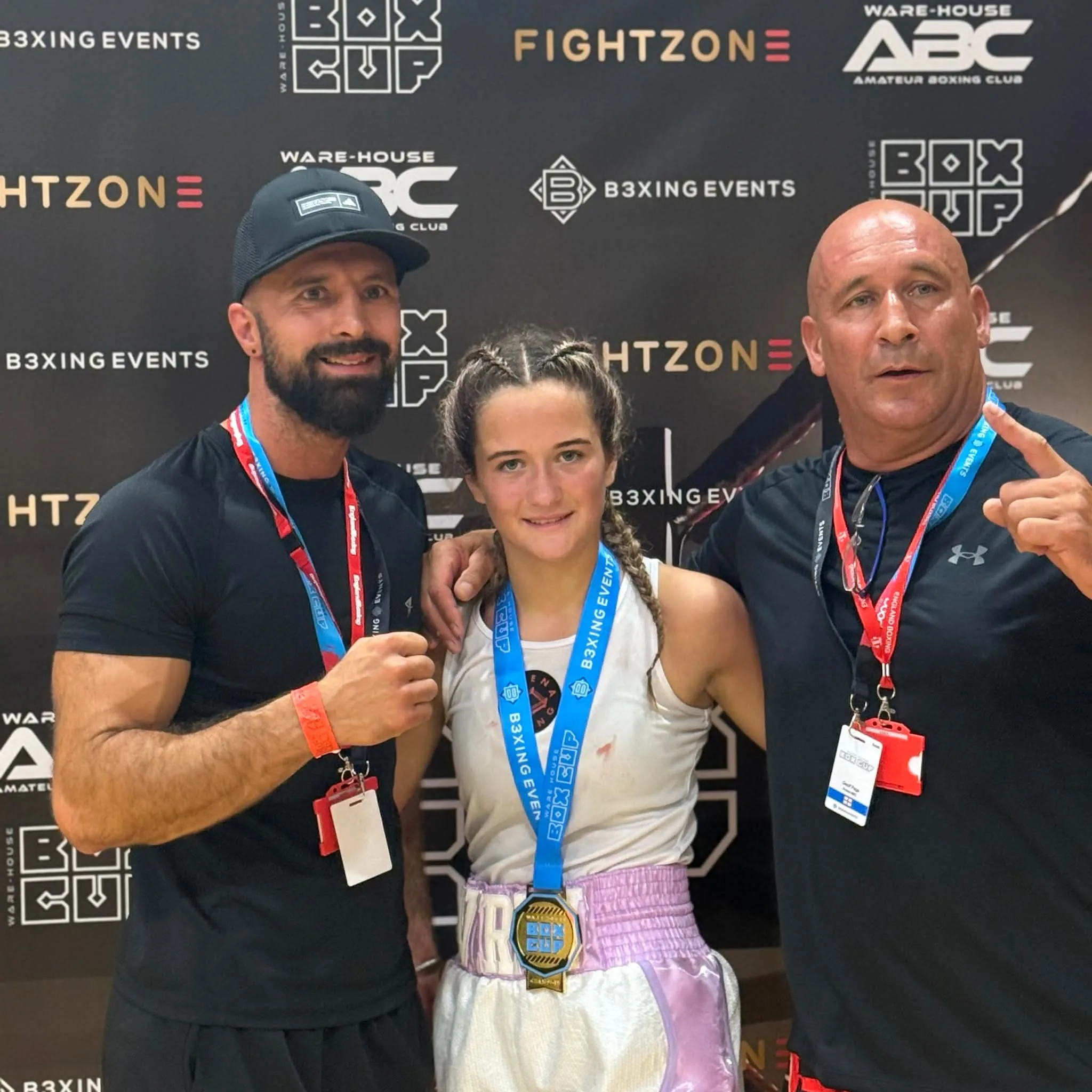 Current Arena boxer celebrating Box Cup success with the coaching team
