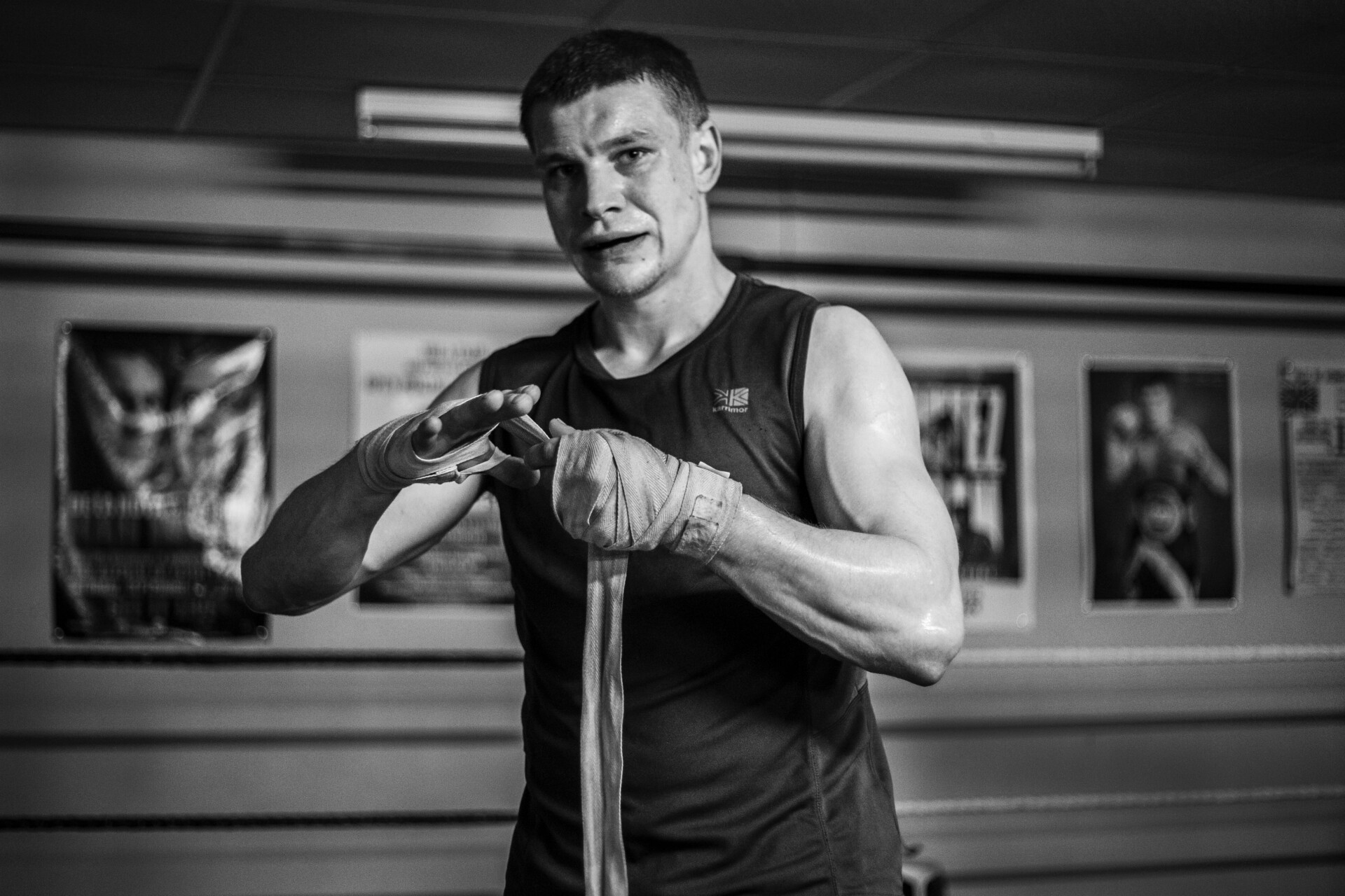 Arena boxer wrapping his hands before training